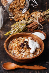 Muesli granola with raisin in wooden bowl