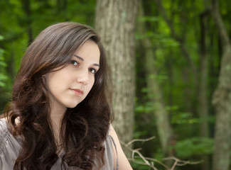 Close-up portrait of a beautiful woman outdoor in the forest.