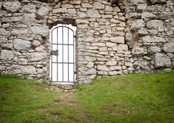 Gate in old stone castle wall, architectural detail