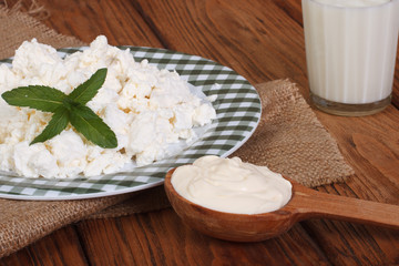 milk, cottage cheese and sour cream on a wooden table