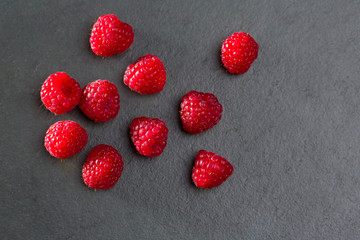 berries raspberry on black slate background