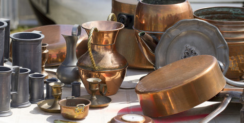 collection of tin and copper pans and pitchers at garage sale - 52364550