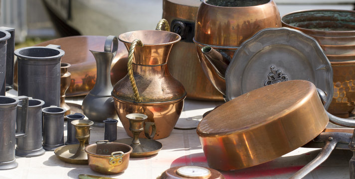 Collection Of Tin And Copper Pans And Pitchers At Garage Sale