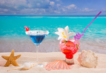 Beach tropical red and blue cocktail on caribbean white sand