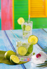 Cuban Mojito cocktail in tropical blue wood flowers and starfish