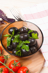 Marinated olives in a transparent plate