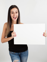 Obraz na płótnie Canvas Young woman holding a white board