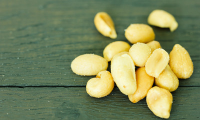 Tasty peanuts on wooden brown table