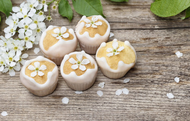 Tiny cakes on wooden background, springtime set.