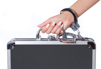 case of money in handcuffs with hand, isolated