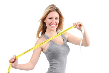 Happy woman stretching a measure tape