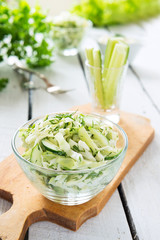 Salad from fresh cabbage, cucumbers and yogurt in bowl