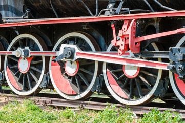 Fototapeta premium Side wheel view of old fashioned steam locomotive on railroad