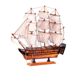 Model sailboat on a white background.