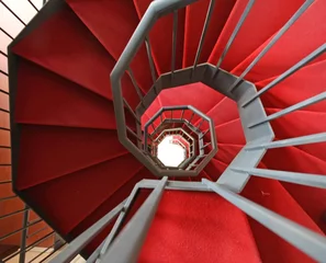 Raamstickers Iron spiral staircase with elegant red carpet and spiral © ChiccoDodiFC