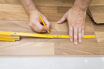 Fototapeta na wymiar Installing wooden laminate flooring