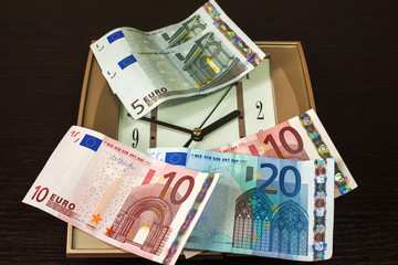 money lying on the square wall clocks