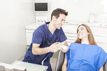 Dentist showing a client something about dental treatament