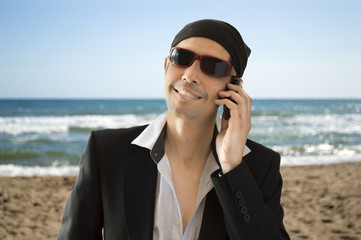 parody of a Latin lover calling by phone on the beach