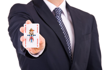 Businessman showing playing card.