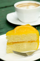 Closeup of orange cake and hot coffee