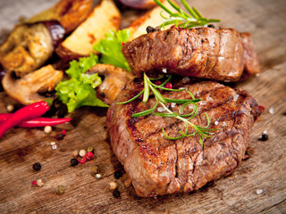 Grilled steaks on wood