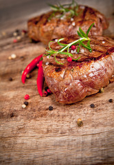 Grilled steaks on wood