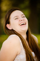 Portrait of happy teenage or adolescent girl outdoors