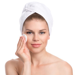 Skin care woman. Pretty model removing makeup, isolated