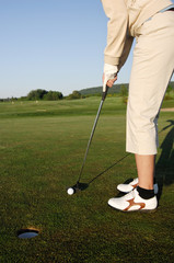 Fototapeta na wymiar Golf serie, woman playing golf on a course