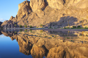 Fototapeta na wymiar Mountain with reflections in a river, Fint Oasis.
