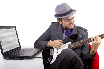 Guitarist looking at tablature online.  