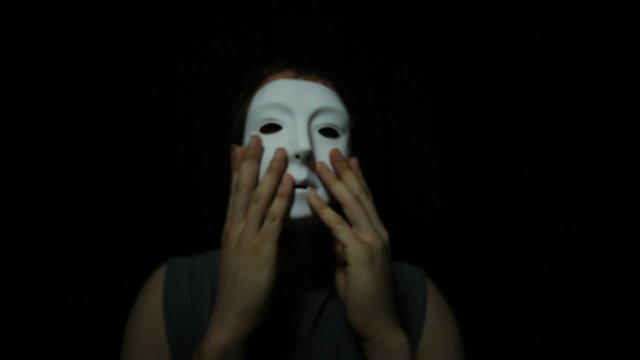 Man with scary mask over black background