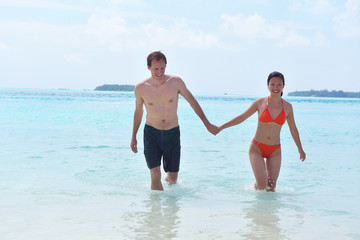 happy young couple have fun on beach