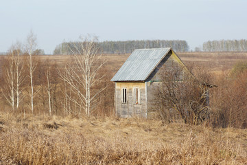 abandoned farmhouse in field