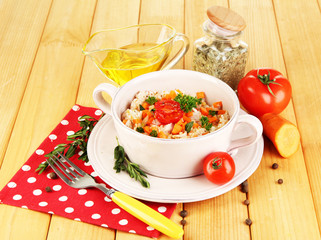 Delicious rice with vegetables and herbs in pot