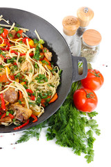 Noodles with vegetables on wok isolated on white