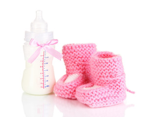 Bottle for milk formula with booties isolated on white