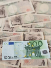 100 euro note isolated on Japanese yen note background