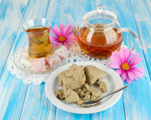 Tasty halva with tea on table