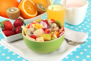 Useful fruit salad of fresh fruits and berries in bowl