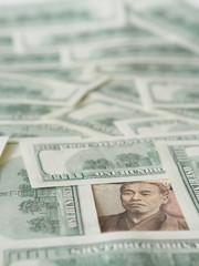 10000 Japanese yen note isolated on US dollar note background