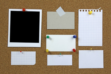cork notice board with blank photo and notes