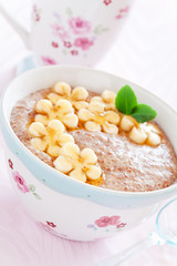 Oatmeal porridge with banana and flax seed, selective focus