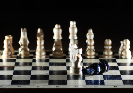 Composition with chessmen on glossy chessboard