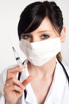 portrait of woman doctor with a syringe, isolated on white backg