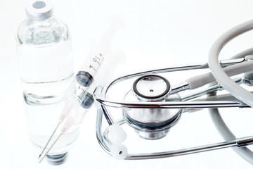Medical ampoules, syringe and stethoscope