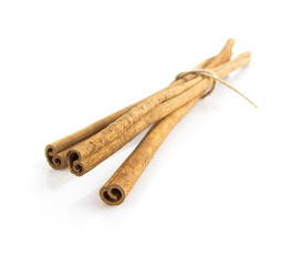 long cinnamon sticks isolated on white background