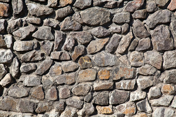 Old gray granite stone wall