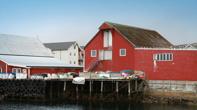 Red wooden houses and packed fishing nets